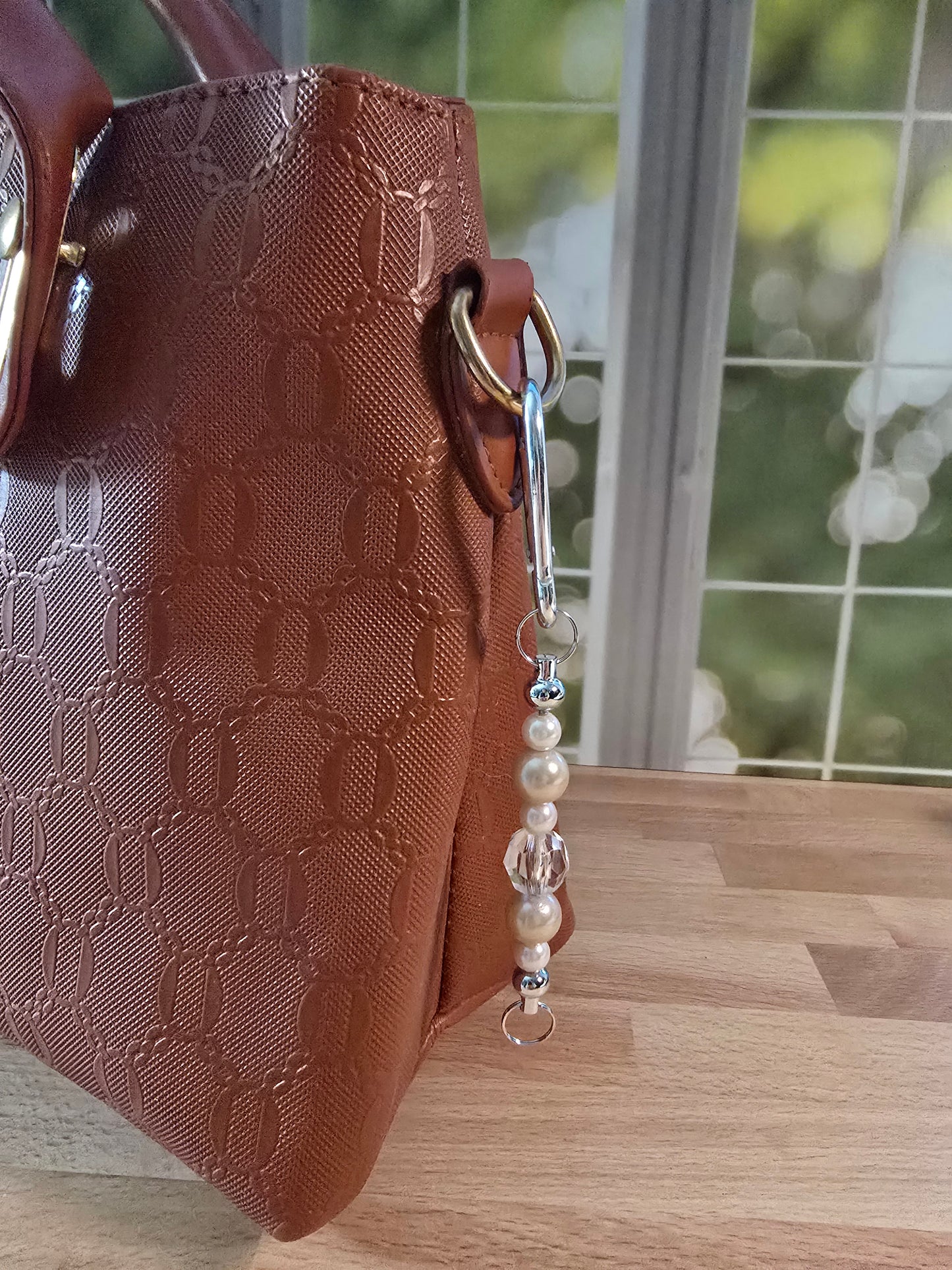 neutral beaded clip attached to bag