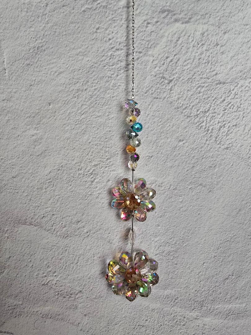 Floral Radiance Suncatcher featuring two stacked iridescent crystal flowers with a vertical beaded stem in soft rainbow tones