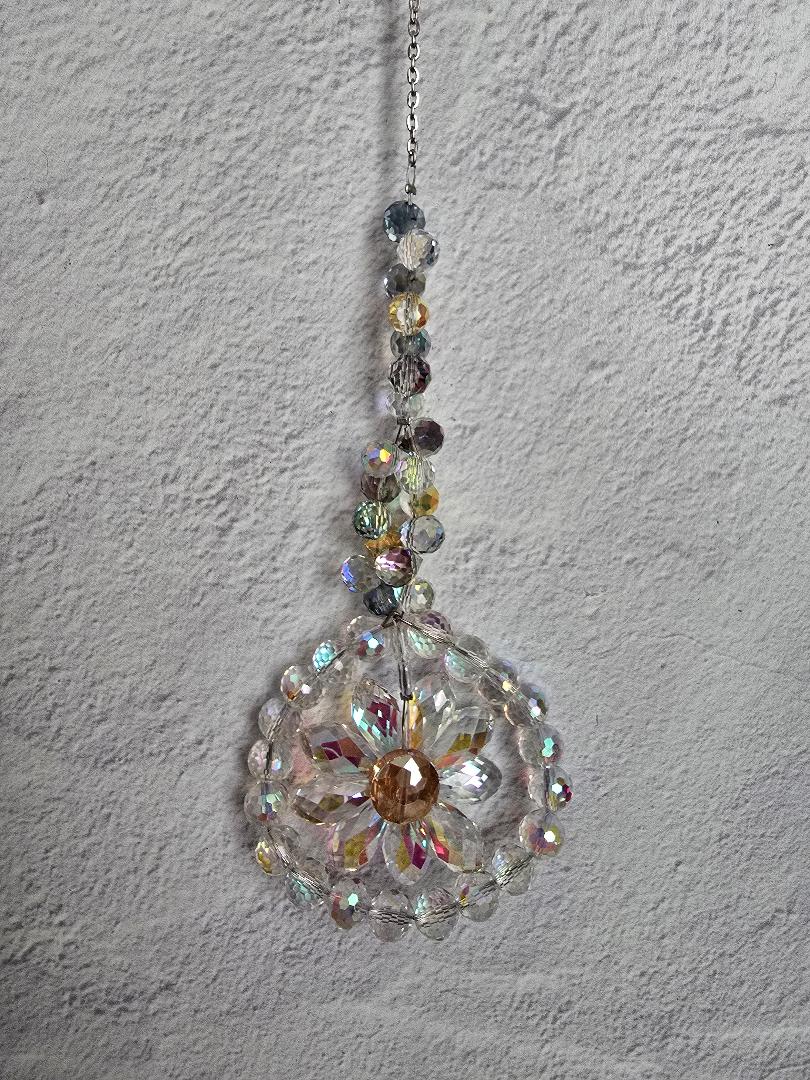 Floral Radiance Suncatcher featuring a clear iridescent faceted crystal flower framed by clear beads with a neutral multicolor beaded stem