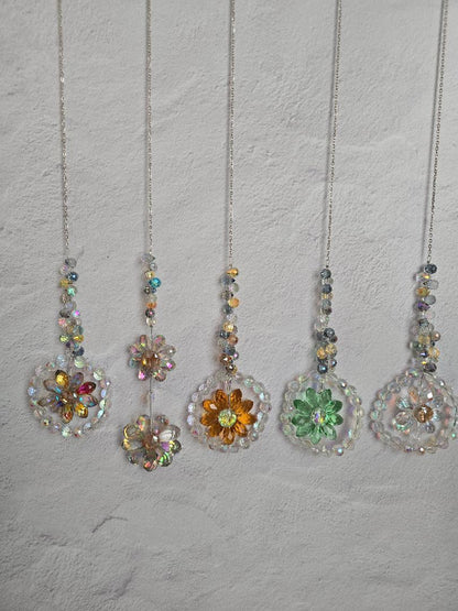 Five Floral Radiance Suncatchers hanging in a row against a light textured background, each featuring crystal beaded stems and multi-color faceted flower pendants