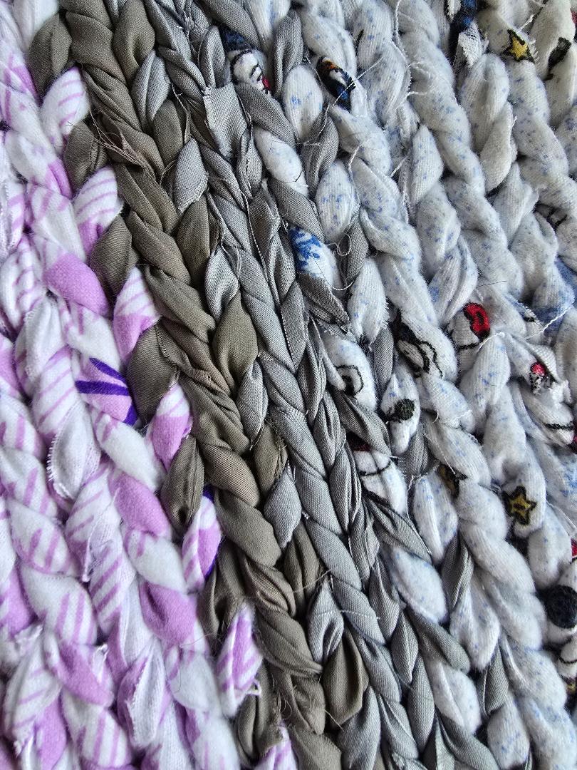 Lavender Ash hand-twined cotton rug close-up showing braided texture in soft lavender, ash gray, and flecked neutral tones