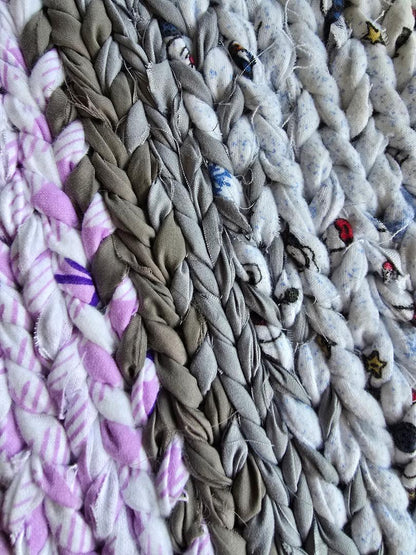 Lavender Ash hand-twined cotton rug close-up showing braided texture in soft lavender, ash gray, and flecked neutral tones