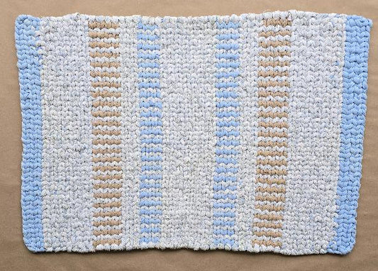 Hand-woven cotton rug named Driftline Beginnings, featuring a rectangular striped pattern in white, natural tan/sand, and pale sky blue. The rug is approximately 37 by 26 inches.