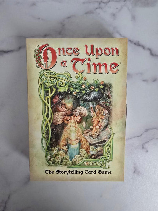 Once Upon a Time storytelling game box shown from above on a marble background